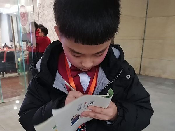 李明骏认真整理采访笔记。.jpg 李明骏认真整理采访笔记。.jpg